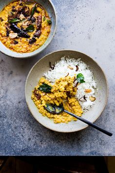 two bowls filled with food sitting on top of a table next to another bowl full of rice