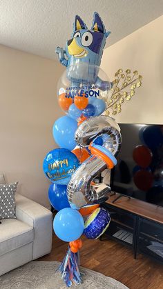 the balloon tower is decorated with blue and orange balloons, including an angry birds character