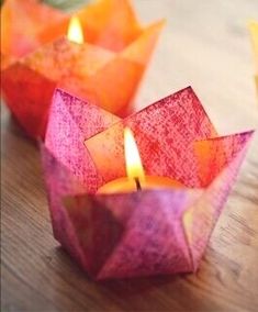 three small candles sitting on top of a wooden table