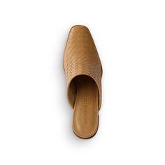 Cultivate ease. This architectural, heeled mule combines a minimalist shape with a timeless, handcrafted woven leather upper. Equal parts classic and modern, it also features a stacked heel intentionally constructed for all-day wear. Heeled Mule Leather upper and lining Rubber Sole Cushioned Footbed Made in Brazil Fits True to Size Slip-On Closure Chic Woven Leather Mules With Open Heel, Modern Mules With Branded Insole And Open Heel, Brown Modern Mules With Pointed Toe, Modern Brown Pointed Toe Mules, Modern Brown Mules With Pointed Toe, Elegant Leather Mules With Woven Sole, Elegant Pointed Toe Heels With Woven Sole, Elegant Heels With Woven Sole And Pointed Toe, Chic High Heel Mules With Woven Sole