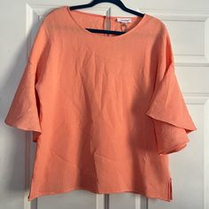 Nwt (New With Tags) Calvin Klein Blouse. Size Medium. See Photos For Approximate Flat Lay Measurements. This Is An Oversized Blouse That Is Meant To Fit Bigger. This Blouse Is In A Coral/Peach Color And Is Textured. It Features Large Bell Sleeves. Super Cute Piece! Orange Short Sleeve Blouse For Spring, Peach Short Sleeve Summer Blouse, Peach Short Sleeve Blouse For Summer, Chic Orange Short Sleeve Top, Chic Pink Stretch Blouse, Pink Blouse For Brunch, Peach Stretch Top For Spring, Feminine Peach Tops For Spring, Feminine Peach Top For Spring