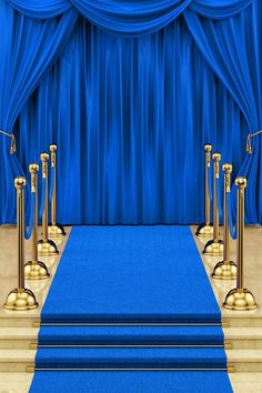 a blue carpeted stage with gold poles and steps leading up to the stage curtain