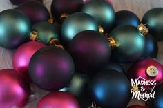 a bunch of purple and green christmas ornaments