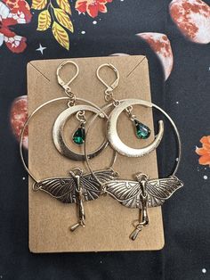 Discover timeless elegance with these vintage boho-inspired earrings.Adorned with a a captivating water drop tassel design and meticulously handcrafted Luna moth drops, each pair is a unique masterpiece for your jewelry collection. Crafted from high quality materials, these earrings are designed for enduring beauty, ensure in you can enjoy them for years. Versatile enough for any occasion, whether you're dressing up for a special event or adding a touch of charm to your casual day out.  Measurements: 3.15 inches long x 1.69 inches in width. Festival Jewelry With Dangling Drop Earrings, Bohemian Teardrop Jewelry For Party, Bohemian Teardrop Earrings For Parties, Bohemian Teardrop Dangle Earrings For Party, Festival Jewelry Drop Earrings With Dangling Charms, Festival Drop Earrings With Dangling Charms, Metal Teardrop Dangle Earrings For Festivals, Teardrop Chandelier Earrings With Dangling Charms As Gift, Bohemian Metal Teardrop Earrings For Party