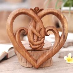 a carved wooden heart on top of a table