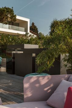 an outdoor patio with furniture and trees in the background