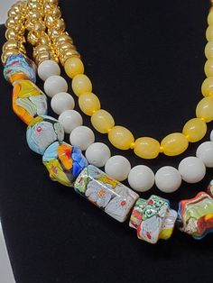 "Beautiful vintage Murano glass beads and dyed jade beads create a one of a kind necklace. Gold rings add shine to the top half of each strand. The necklace has a toggle clasp. ●Dimensions: L:22\" ●Linda's Designers Group features a collection of unique fine china, luxury estate sale handbags, vintage statement jewelry and handmade 'one of a kind' jewelry. We will gladly provide additional images or information, contact us through this site or our Facebook page. Follow us on Facebook and Instagr Unique Murano Glass Necklace With Large Beads, Unique Murano Glass Necklaces With Large Beads, Unique Murano Glass Beaded Necklaces, Colorful Glass Beaded Jewelry, Colorful Murano Glass Beaded Necklaces, Glass Multi-strand Necklace With Colorful Beads, Multi-strand Glass Beaded Colorful Necklace, White Bohemian Necklace In Glass, White Glass Beaded Necklace With Large Beads