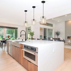 a large kitchen with an island in the middle