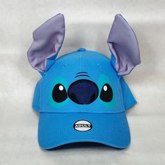 New To Poshmark? Sign Up And Use The Code: Disneyandmore To Get $10 Off Your First Purchase! Condition: New Size: Adjustable With Hook & Loop Strap / One Size Fits All Color: "Stitch" Blue Material: 100% Cotton This Disney Character Hat Looks Just Like The Fan Favorite Alien From Disney's 2002 Lilo And Stitch Movie. The Stitch Baseball Hat Includes 3d Ears, Printed Eyes And An Embroidered Nose Details. This Hat Is Perfect To Wear For A Day At Disney Theme Parks Or For Wearing When Your With Your Lilo And Stitch Movie, Stitch Movie, Stitch Hat, Stitch Blue, Hat Patches, Disney Lilo, Disney Theme Parks, Disney Accessories, Disney Character