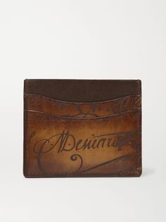 In this digital age, artisan craftsmanship is all the more special, something that Berluti knows well. This cardholder is made from the brand's famous Venezia leather which is hand-treated for a rich patina and shine, and inscribed with cursive lettering that references an 18th century manuscript found at auction. Its slim profile is fitted with four slots and a central compartment. Luxury Embossed Leather Wallet, Luxury Leather Embossed Wallets, Designer Leather Card Holder With Engraved Logo, Leather Card Holder With Engraved Logo, Formal Rectangular Card Holder With Engraved Logo, Rectangular Card Holder With Engraved Logo, Designer Brown Card Holder As Gift, Designer Brown Card Holder For Gift, Designer Brown Card Holder