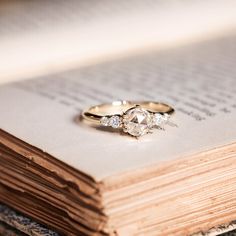 two rings sitting on top of an open book