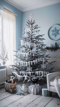 a white christmas tree in a living room next to a radiator and window