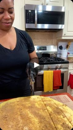 a woman standing in front of a pancake on top of a counter