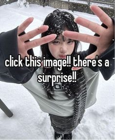 a woman making the vulcan sign with her hands in the air while snow falls on her