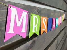 a colorful banner hanging from the side of a wooden wall