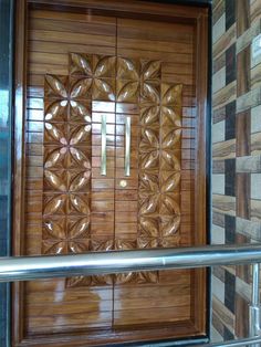 a wooden door with metal bars in front of it and tile on the wall behind it