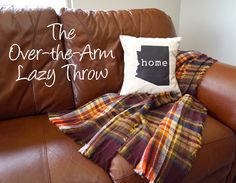 a brown leather couch with a throw blanket and pillow on it that says the over - the - arm lazy throw