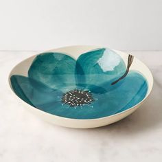 a white and blue bowl sitting on top of a table