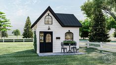 a small white house sitting on top of a lush green field next to a fence