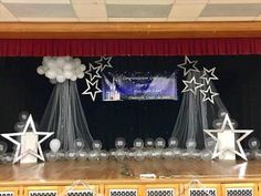 the stage is set up with balloons and stars for an award ceremony or graduation party