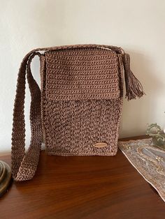 Handmade Brown Crochet Shoulder Bag - Eco-Friendly and Stylish This beautifully handcrafted brown crochet shoulder bag is made from eco-friendly paper yarn, offering a blend of rustic charm and modern practicality. The bag features a flap closure and a unique woven texture, making it both functional and fashionable. The tassel detail adds a touch of boho flair, while the spacious interior is perfect for carrying your everyday essentials. Whether you're headed to work, a casual outing, or just ru Brown Crochet Crossbody Bag For Daily Use, Brown Handwoven Crochet Bag For Daily Use, Brown Crochet Travel Bag, Brown Handwoven Crochet Travel Bag, Brown Macrame Shoulder Bag For Travel, Brown Macrame Bags For Travel, Brown Crossbody Crochet Bag For Daily Use, Brown Crochet Rectangular Bag, Travel Brown Macrame Shoulder Bag