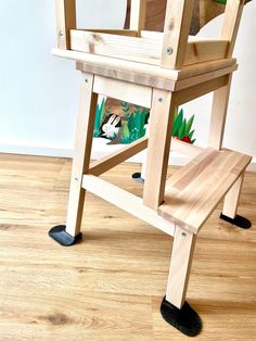 a wooden chair sitting on top of a hard wood floor