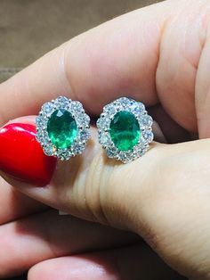 Emerald Earrings is a great way to create a classic, heirloom look you will feel Elegant, princess like immediately. The center stone is Oval in shape and has gorgeous facets. For extra sparkle, it has been framed by 10 round diamonds forming a beautiful halo around. Metal: 18K white goldDiamond Weight: 2.00ct twEmerald Weight: 3.00ct tw Dimensions: L:13mm X W: 13mm Estimated production time is 4 - 5 weeks Emerald And Diamond Earrings, Emerald Earrings, Round Diamonds, Diamond Earrings, Halo, Emerald, Diamonds, Sparkle, Stone