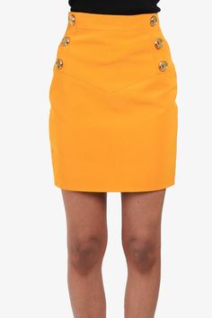 Balmain Orange Bodycon Mini Skirt with Gold Buttons. Back Zipper closure. Lined. Gold-toned hardware. Tonal stitching. Size: 34 (Small)Model's Measurements: 5'7" height x 28” waist x 22.5” bust x 35” hipsCondition: This item is in very good pre-loved condition with original tags intact. Like all our products, we guarantee this item to be authentic. Click here to see our returns policy Mine & Yours is not affiliated with this brand. We guarantee this is an authentic item and is a registered trade Fitted Retro Yellow Mini Skirt, Yellow Stretch Mini Skirt, Yellow Knee-length Lined Mini Skirt, Yellow Mini Skirt With Pockets, Luxury Yellow Mini Skirt, Mens Spring Shoes, Bodycon Mini Skirt, Pop Clothing, Louis Vuitton Shop