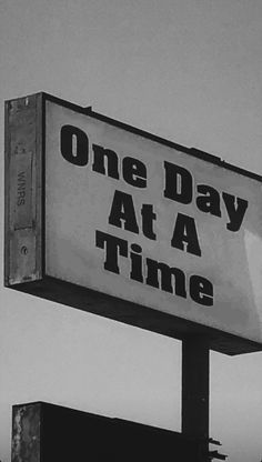 a sign that says one day at a time