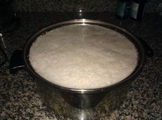 a metal pan sitting on top of a counter covered in white powdered sugar and water