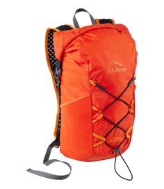 an orange backpack with straps on the front and side pockets, attached to it's back