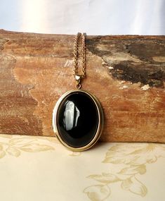 This is a beautiful solid brass vintage (unused) American made locket adorned with a large 30x40mm Black Agate  gemstone cabochon set in a raw brass tray.  The locket which is raw brass will be polished to a warm golden tone and sealed with a wax polish, in time it will darken but can be polished back to golden or left to form its natural patina if desired. The locket is 35x48 (excluding the bail) and is hung from a matching brass 3mm belcher chain and finished with a brass lobster claw clasp. Inside is ample space for photos or keepsakes. Black Agate Stone, Belcher Chain, Brass Tray, Cabochons Stones, Black Agate, Locket Necklace, Agate Gemstone, Agate Stone, Raw Brass