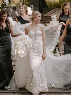 the bride and her bridal party are walking down the stairs