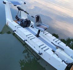 a small boat is docked in the water with its motor on it's side