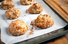 some crab cakes are sitting on a baking sheet and ready to be baked in the oven