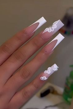 Discover the elegance of white French tips combined with 3D floral nail art, perfect for bridal nails in 2024. These sophisticated designs are ideal for weddings, special occasions, and anyone looking to add a touch of luxury to their manicure. Stay on top of the latest nail trends with this chic and timeless nail art. #nailart #summernails #goldfoilnails #frenchtipnails #naildesign Nails Acrylic New Years Art Ideas, Xv Nails, Quinceanera Nails, Hard Nails, Nails Trends, White Acrylic Nails, Glow Nails