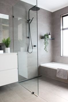 a bathroom with a tub, sink and shower head