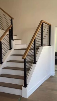 there is a set of stairs in the house that has been painted white and wood