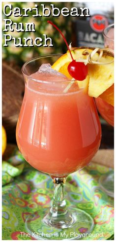 a drink in a glass with fruit on the side