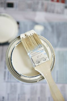 a paint can with a brush in it