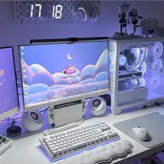 two computer monitors sitting next to each other on top of a white desk with keyboard and mouse