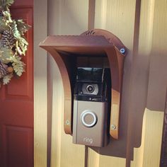 a camera mounted to the side of a wooden door