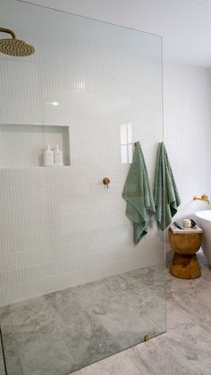 a bathroom with a large glass shower door