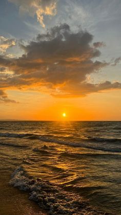 the sun is setting over the ocean with waves