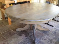 a wooden table sitting on top of a tiled floor