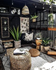 an outdoor patio with plants and wicker furniture