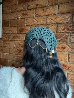 the back of a woman's head wearing a crochet hat