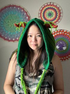 a woman wearing a green crocheted hoodie