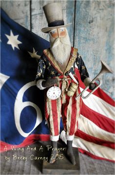 a figurine of a man with a clock and an american flag in the background