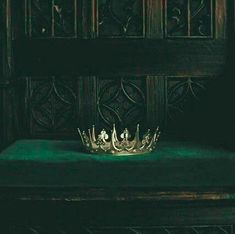 a crown sitting on top of a green table